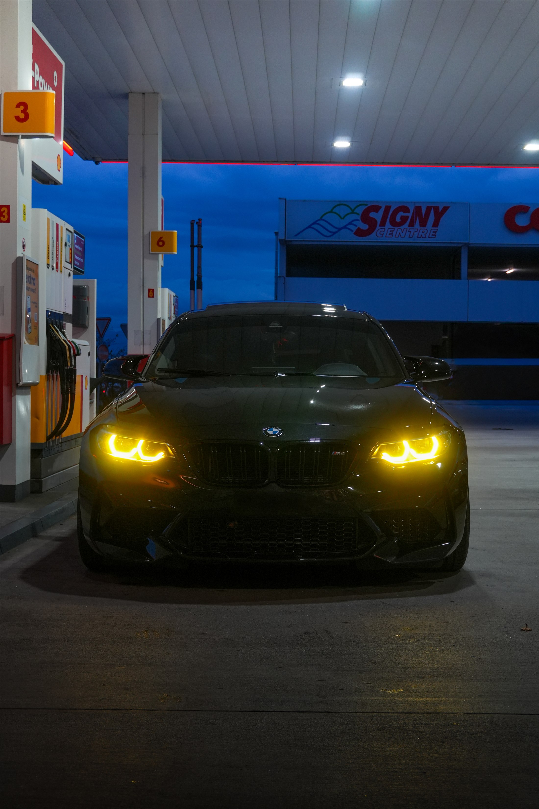 BMW M2 — station essence blue hour